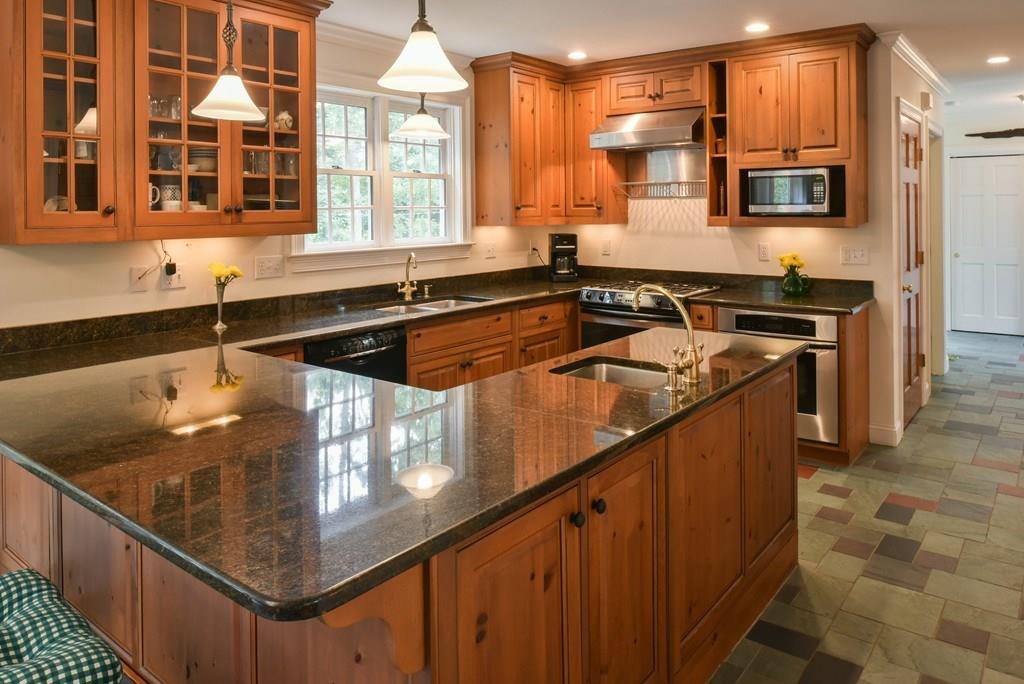 153 Kimball Road Amesbury, MA 01913 - Photo 7 of 17 a kitchen with stainless steel appliances granite countertop a sink stove and microwave