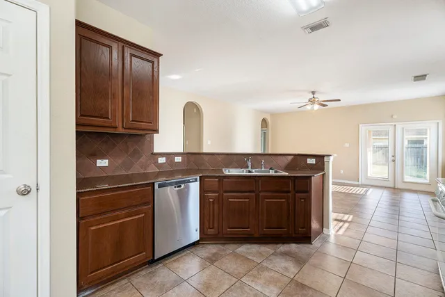 a kitchen with stainless steel appliances granite countertop a stove and a sink