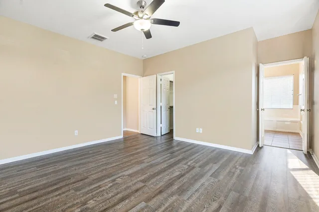 a view of an empty room with wooden floor