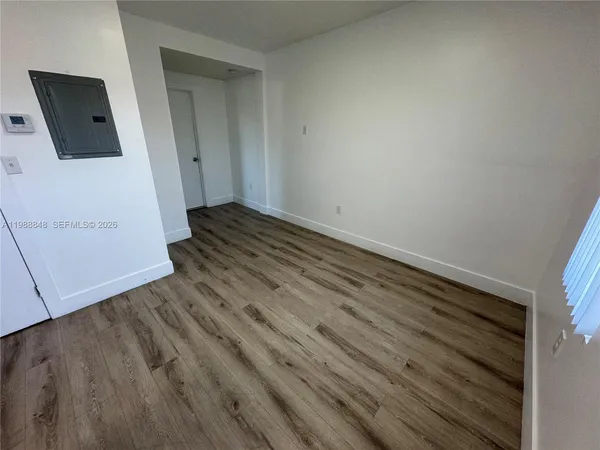 a view of a room with wooden floor