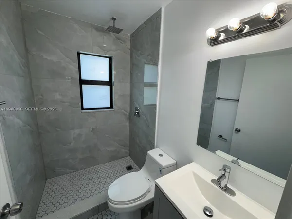 a bathroom with a toilet sink and a shower