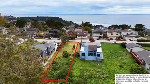 a aerial view of a house with a garden and lake view