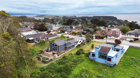 an aerial view of a house with a big yard