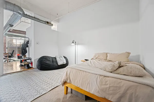 a living room with furniture a flat screen tv and a floor to ceiling window