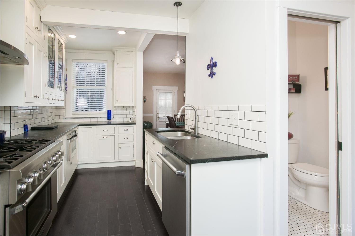 68 Rector Street Metuchen, NJ 08840 - Photo 14 of 40 a kitchen with a sink stove and cabinets