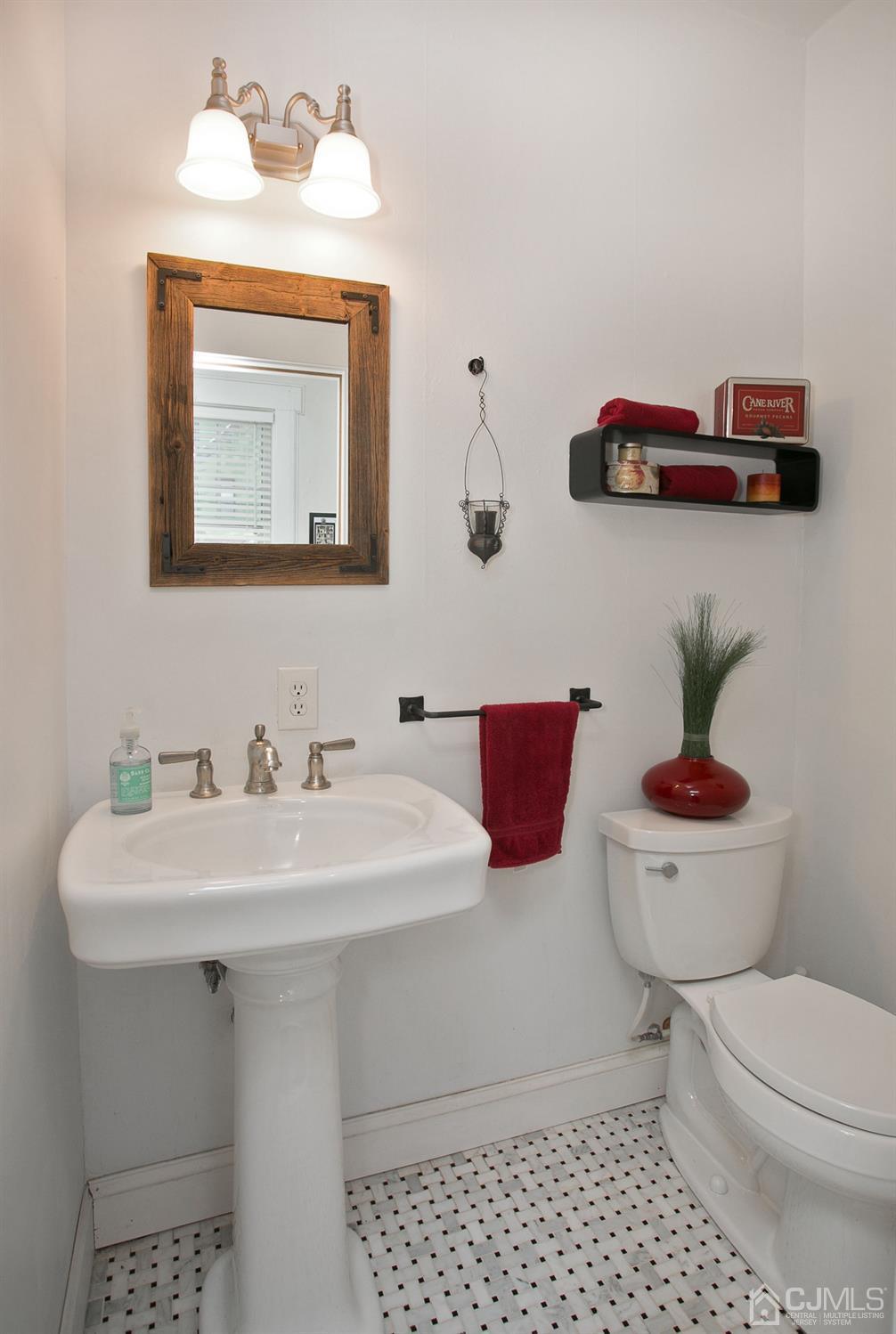 68 Rector Street Metuchen, NJ 08840 - Photo 16 of 40 a bathroom with a toilet a sink and mirror