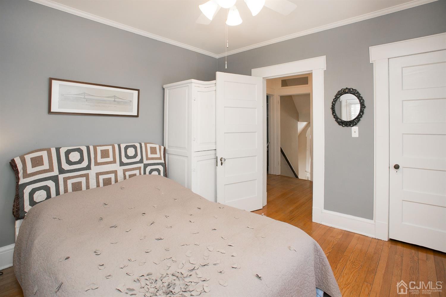 68 Rector Street Metuchen, NJ 08840 - Photo 20 of 40 a bedroom with a bed and a chandelier