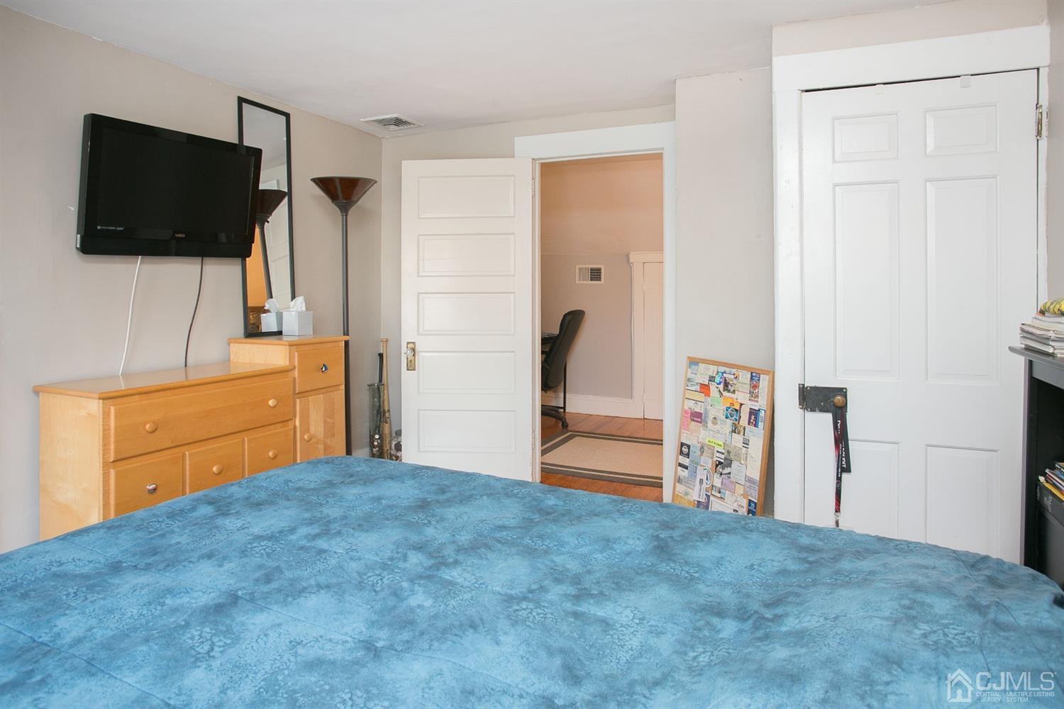 68 Rector Street Metuchen, NJ 08840 - Photo 32 of 40 a bedroom with a bed and a flat screen tv