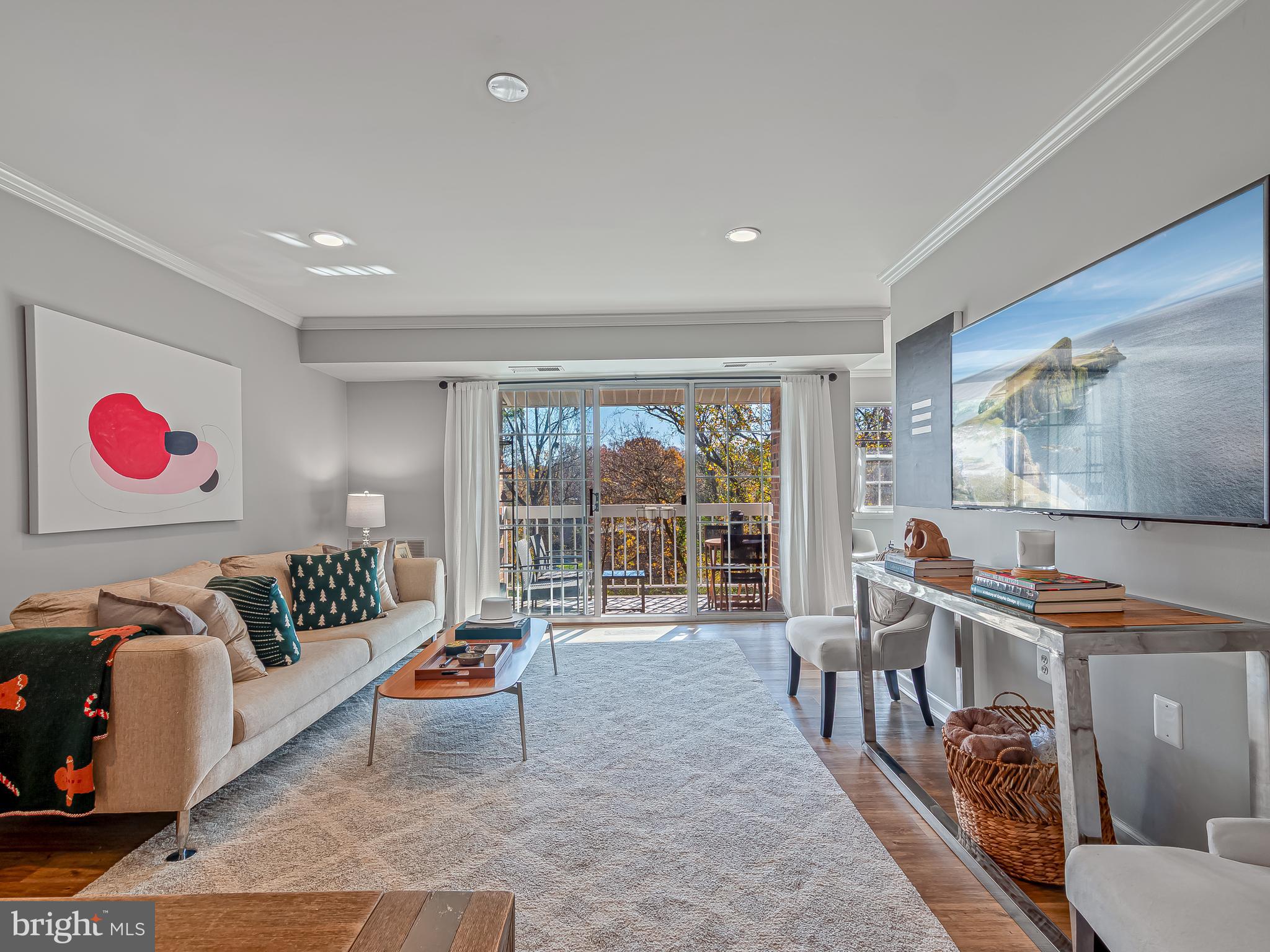 1914 Wilson Lane, Unit 202 McLean, VA 22102 - Photo 11 of 42 a living room with furniture and a floor to ceiling window