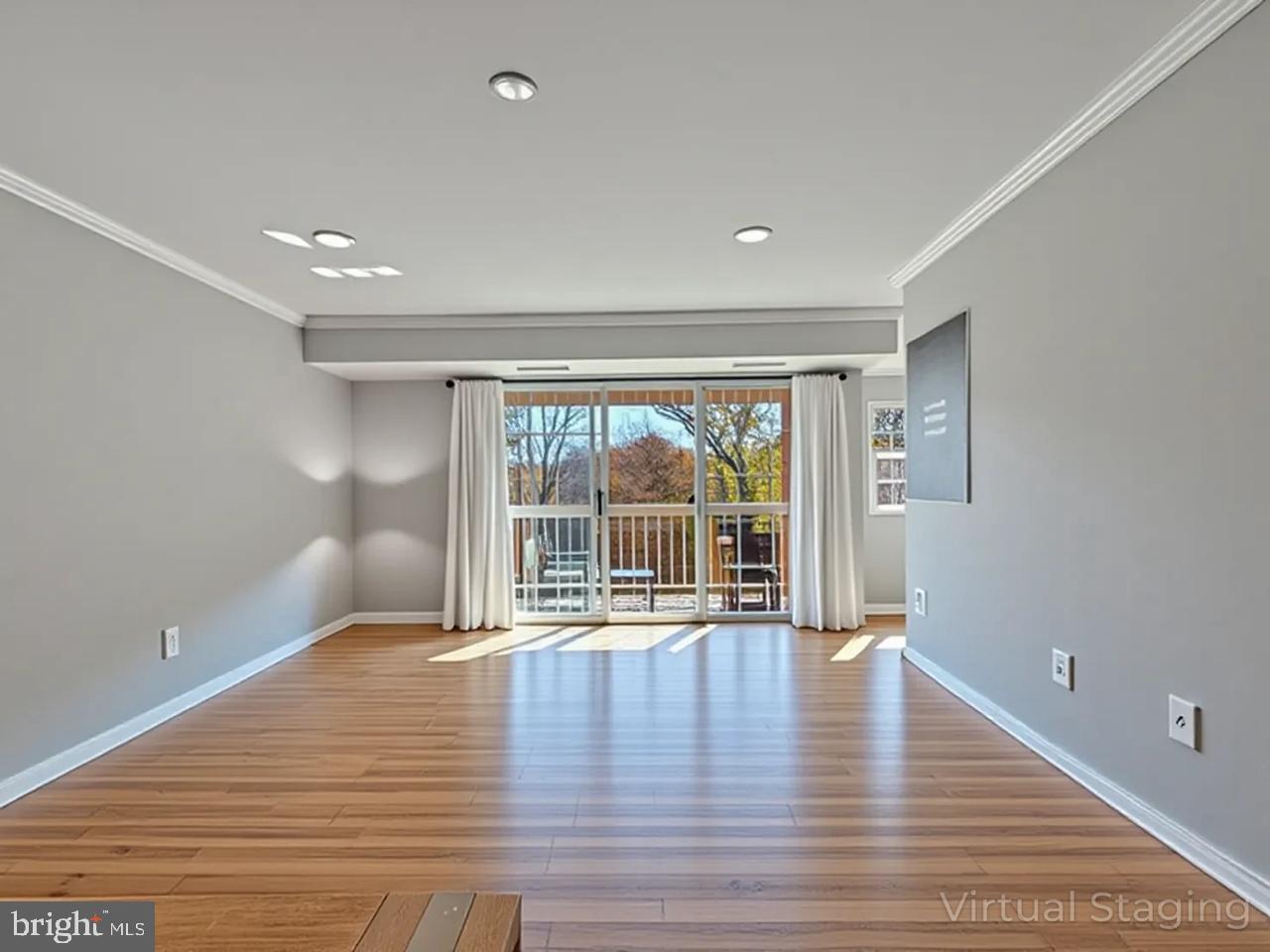 1914 Wilson Lane, Unit 202 McLean, VA 22102 - Photo 12 of 42 a view of an empty room with wooden floor and a window