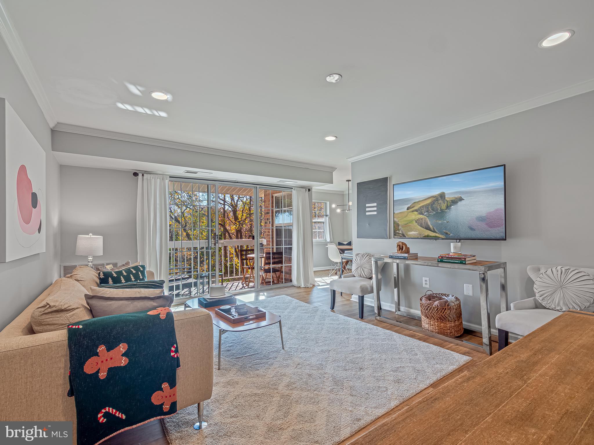 1914 Wilson Lane, Unit 202 McLean, VA 22102 - Photo 13 of 42 a living room with furniture and a flat screen tv