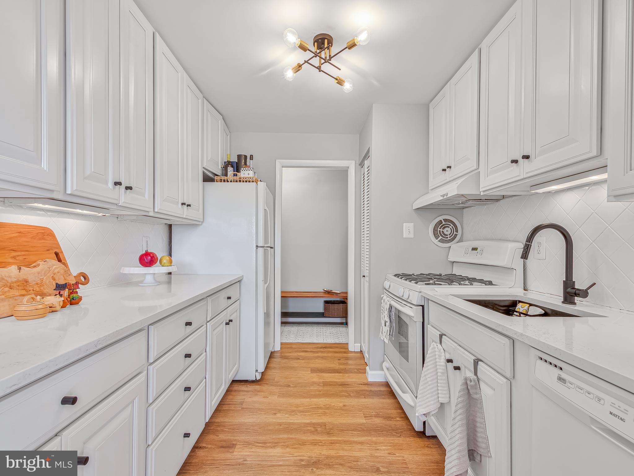 1914 Wilson Lane, Unit 202 McLean, VA 22102 - Photo 17 of 42 a kitchen with white cabinets and sink