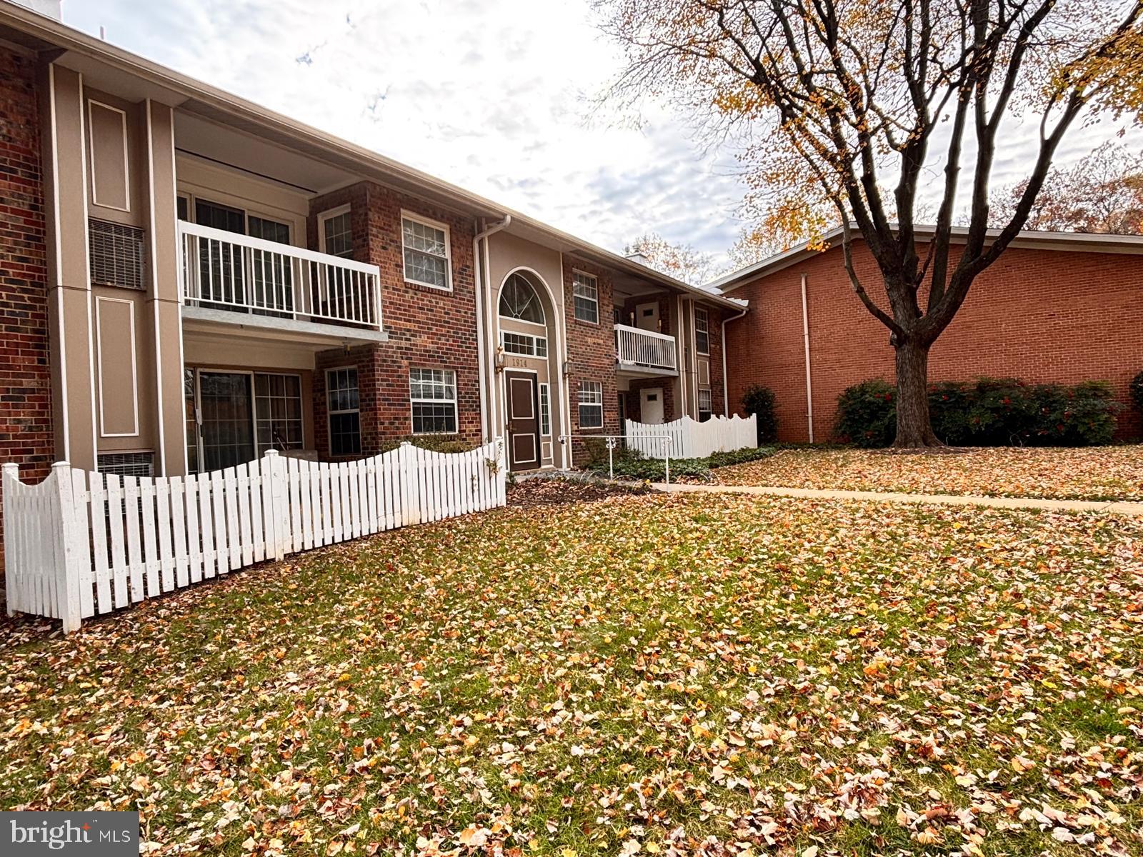 1914 Wilson Lane, Unit 202 McLean, VA 22102 - Photo 2 of 42 a front view of a house with a yard
