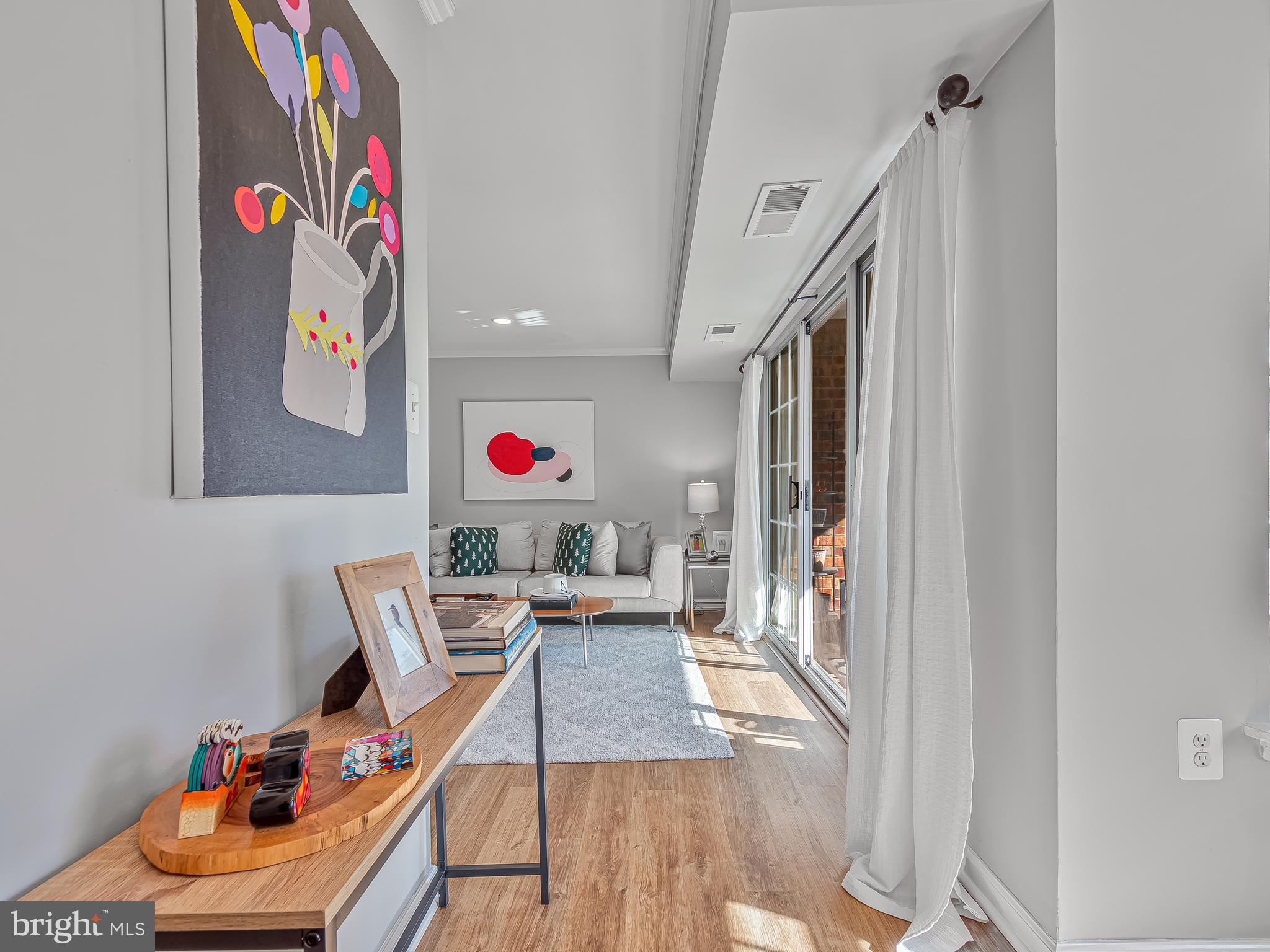 1914 Wilson Lane, Unit 202 McLean, VA 22102 - Photo 21 of 42 a living room with furniture and a wooden floor