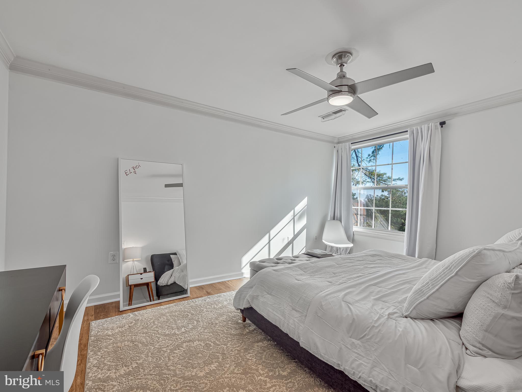 1914 Wilson Lane, Unit 202 McLean, VA 22102 - Photo 24 of 42 a bedroom with a bed and a chandelier