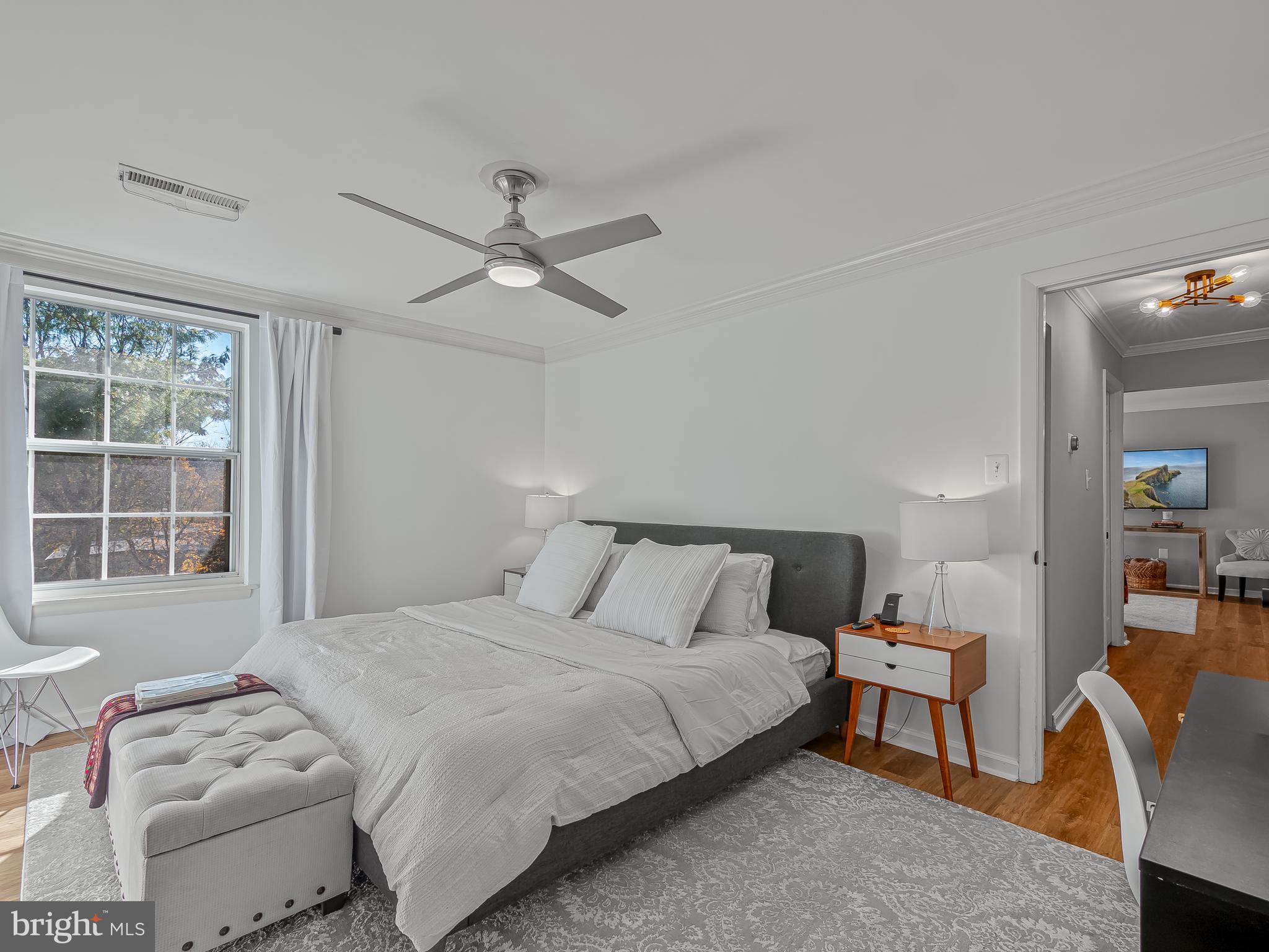 1914 Wilson Lane, Unit 202 McLean, VA 22102 - Photo 25 of 42 a bedroom with a bed and a window with chair