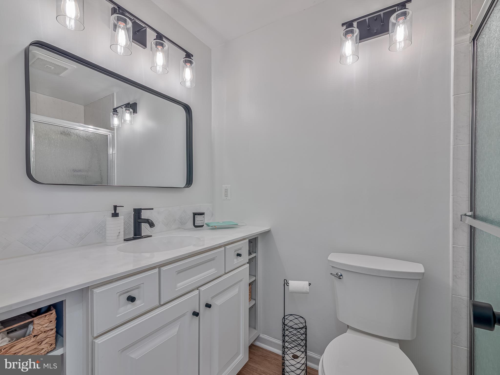 1914 Wilson Lane, Unit 202 McLean, VA 22102 - Photo 29 of 42 a bathroom with a toilet sink and mirror