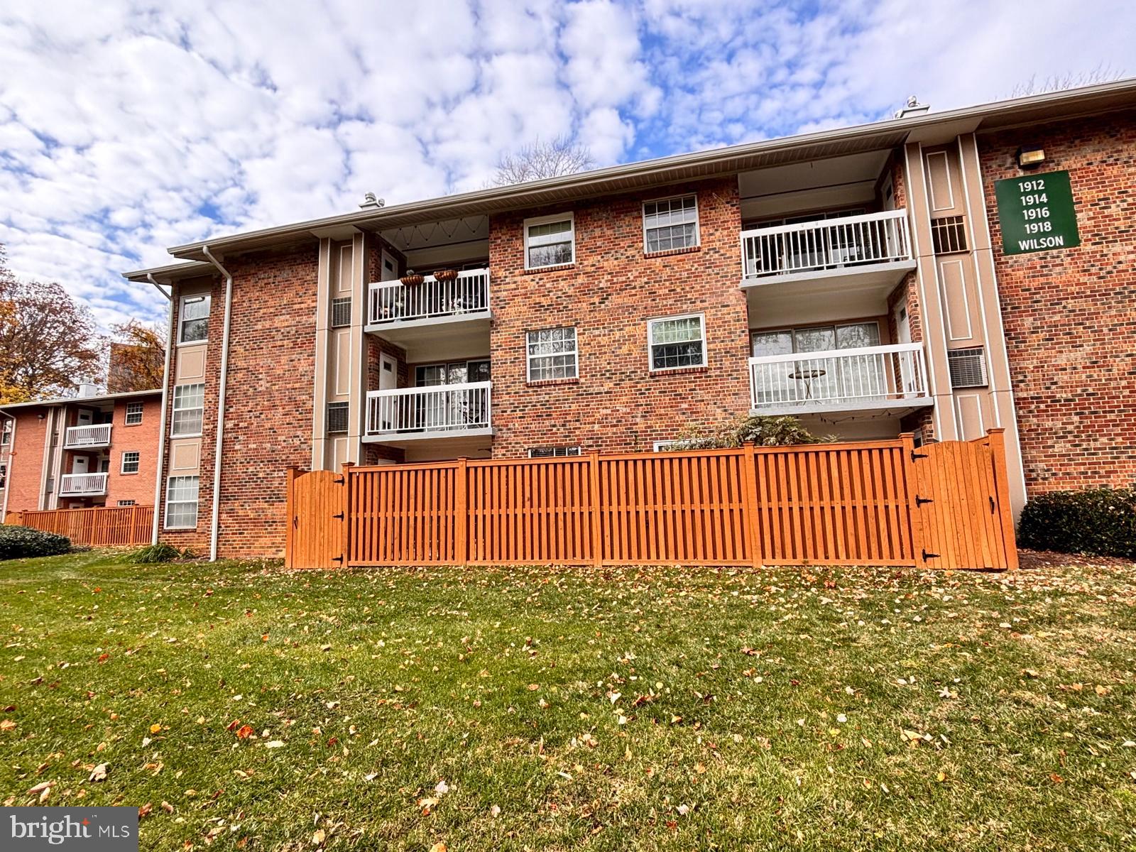 1914 Wilson Lane, Unit 202 McLean, VA 22102 - Photo 36 of 42 a front view of a house with a garden