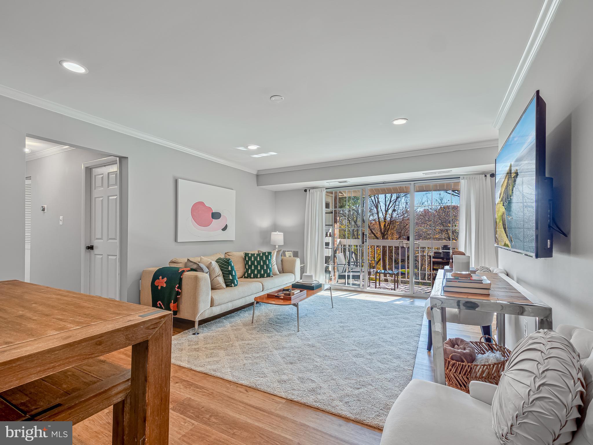 1914 Wilson Lane, Unit 202 McLean, VA 22102 - Photo 9 of 42 a living room with furniture and a table
