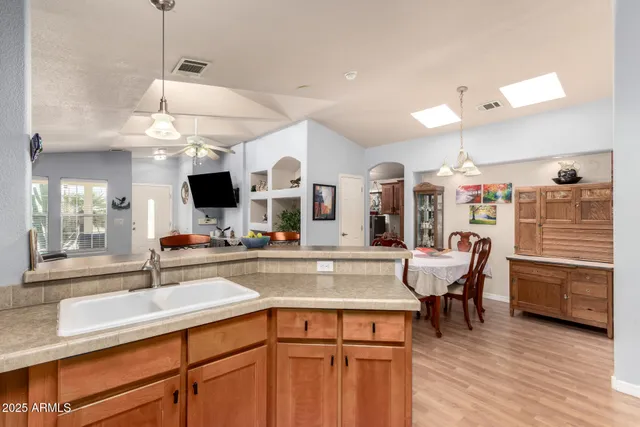 a kitchen with a sink cabinets and wooden floor