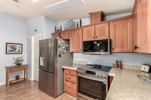 a kitchen with stainless steel appliances a stove a microwave and a refrigerator
