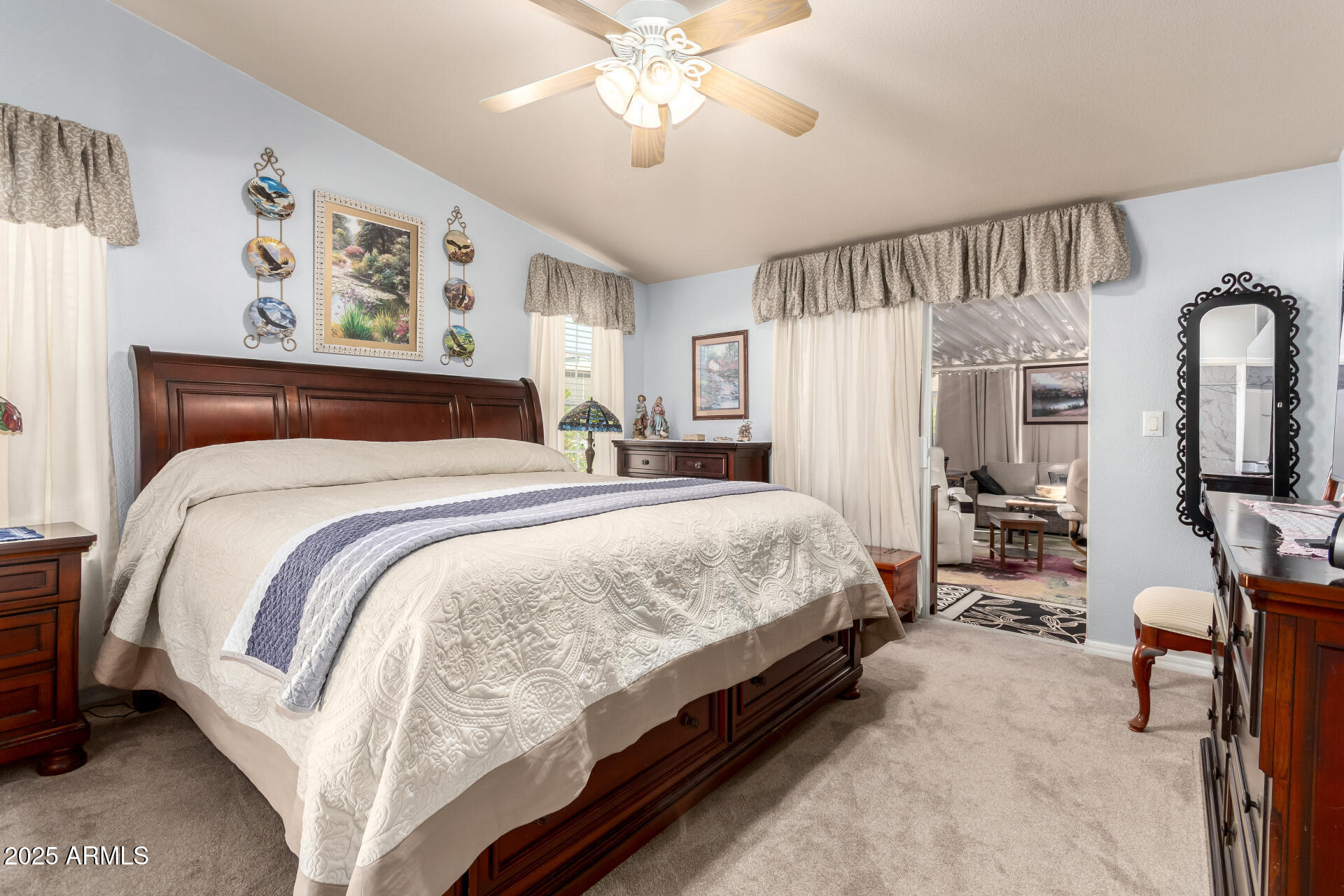 3301 South Goldfield Road, Unit 2122 Apache Junction, AZ 85119 - Photo 20 of 35 a bedroom with a bed and a chandelier