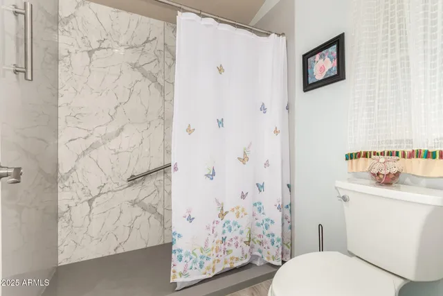 a white toilet sitting next to a bathroom sink
