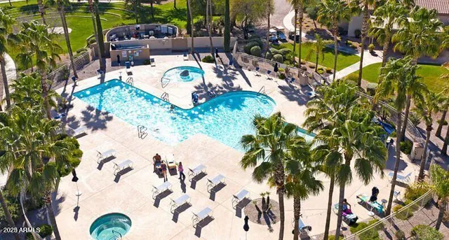 a view of swimming pool with a garden and seating area