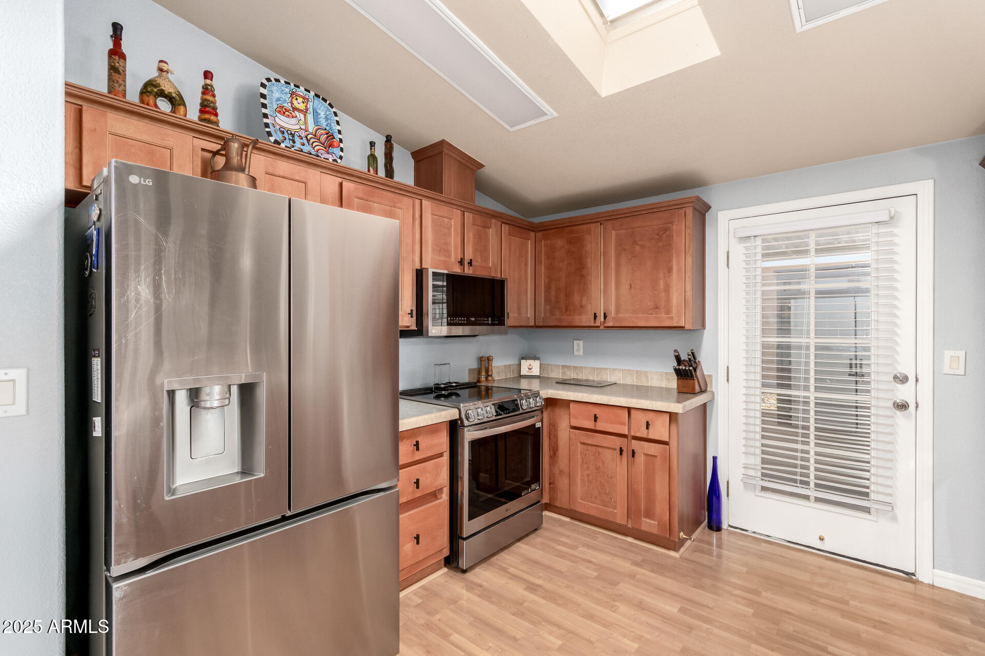 3301 South Goldfield Road, Unit 2122 Apache Junction, AZ 85119 - Photo 5 of 35 a kitchen with stainless steel appliances granite countertop a refrigerator stove and sink
