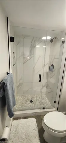 a bathroom with a double vanity sink toilet and mirror