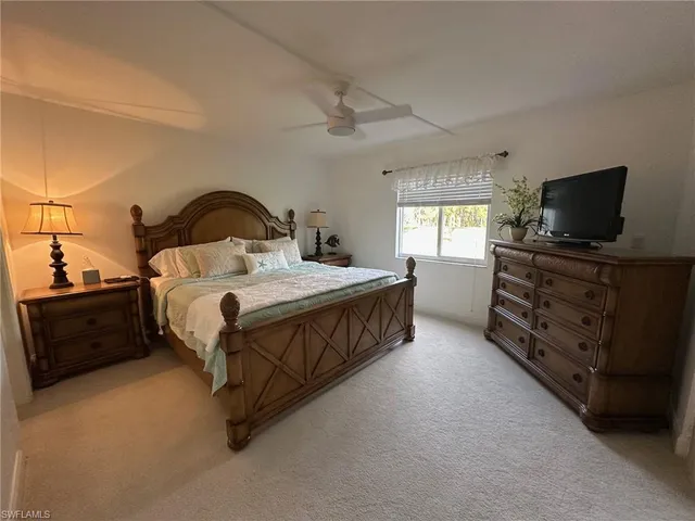 a bedroom with a bed and a flat screen television