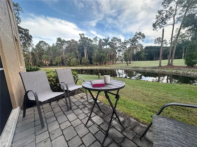a backyard of a house with table and chairs