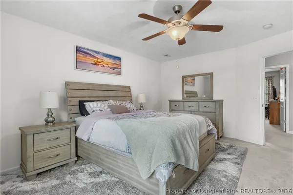a bedroom with a large bed and a flat screen tv