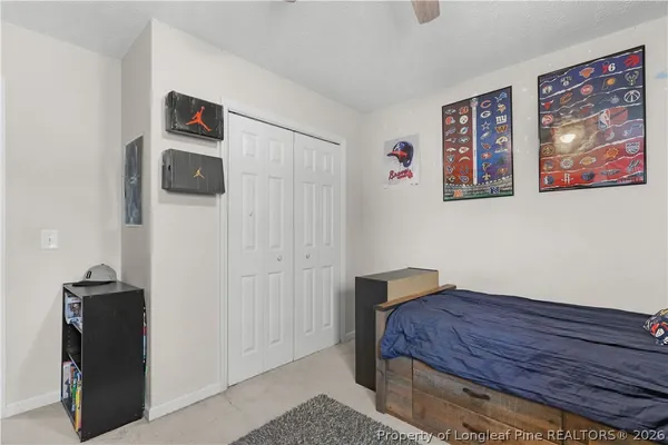 a living room with furniture and a ceiling fan