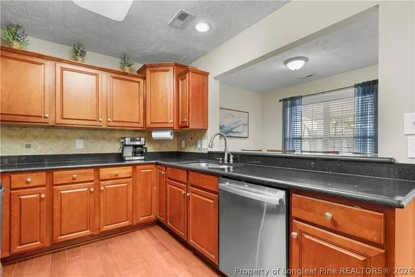 a kitchen that has a sink and cabinets