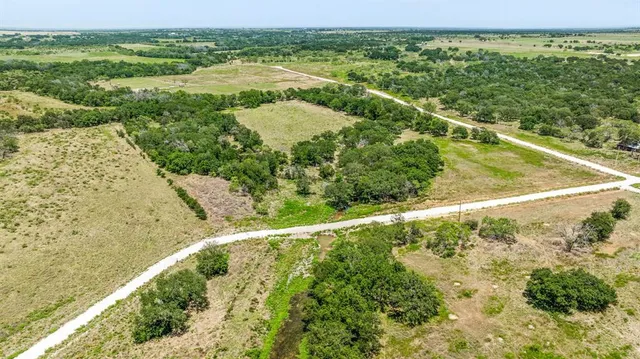 a view of a field with an ocean view