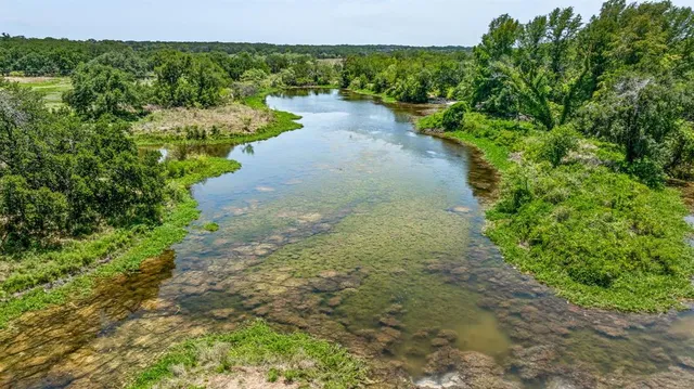 a view of a lake with a yard