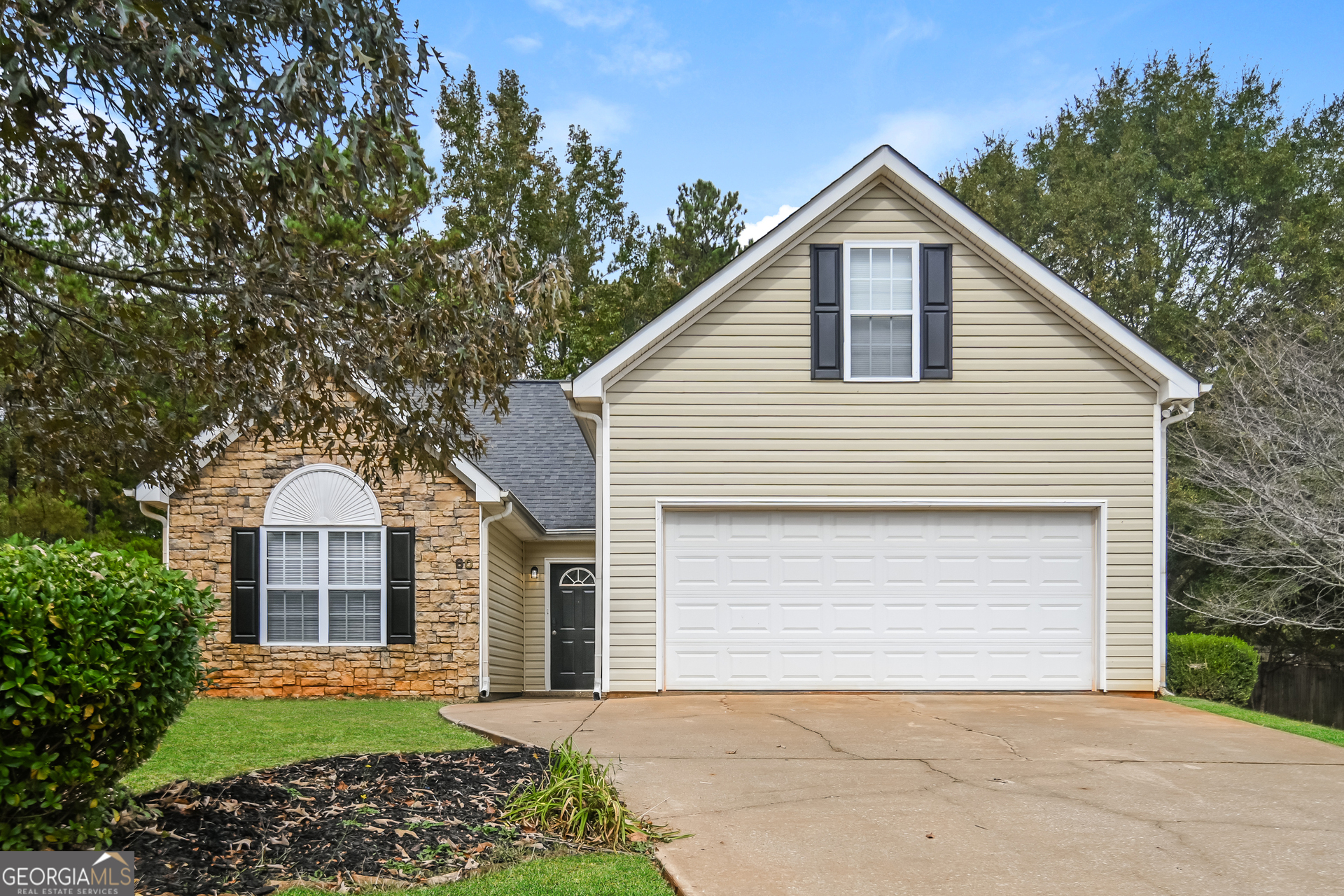 a front view of a house with a garden
