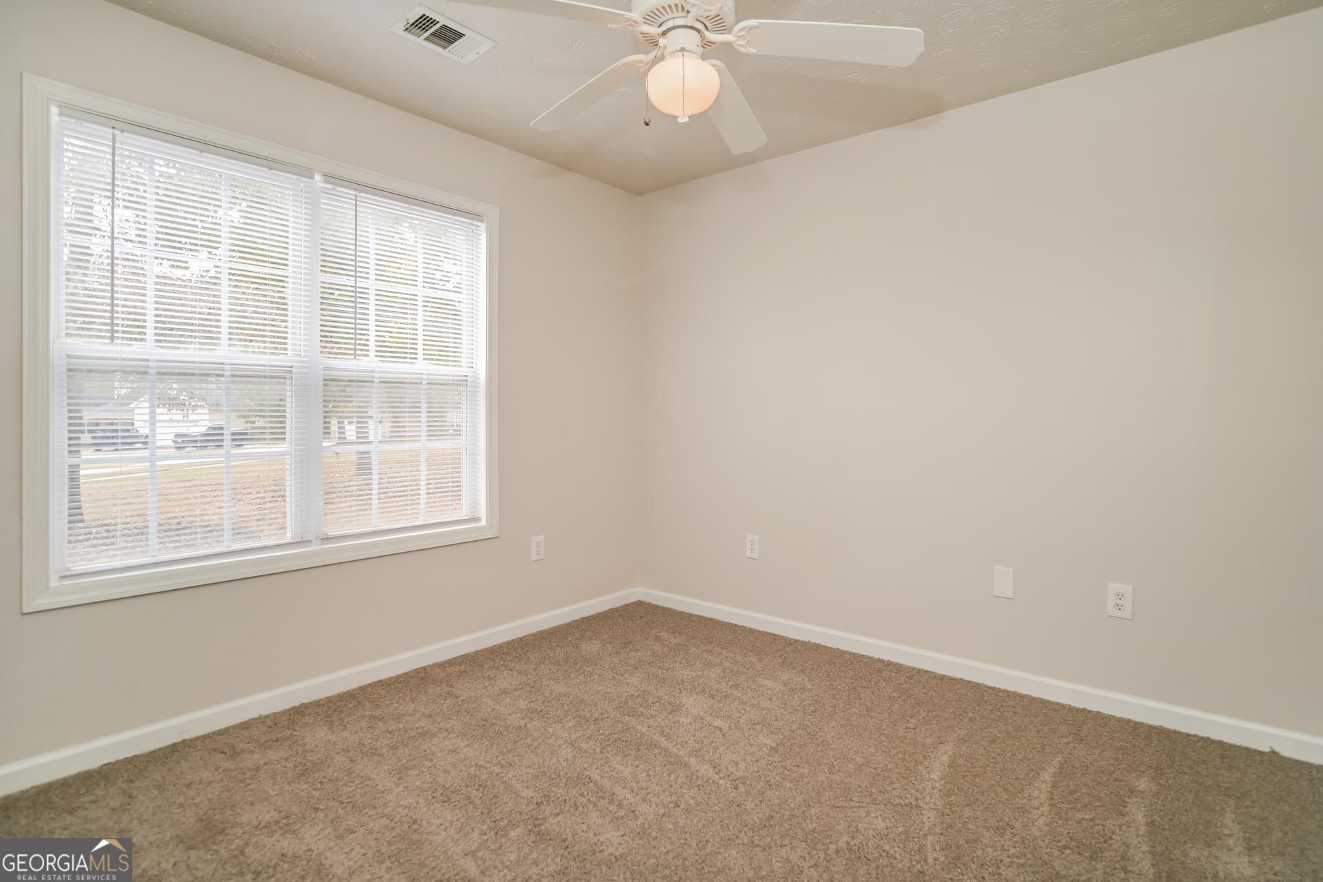 60 Freeman Way Covington, GA 30016 - Photo 11 of 17 an empty room with a window