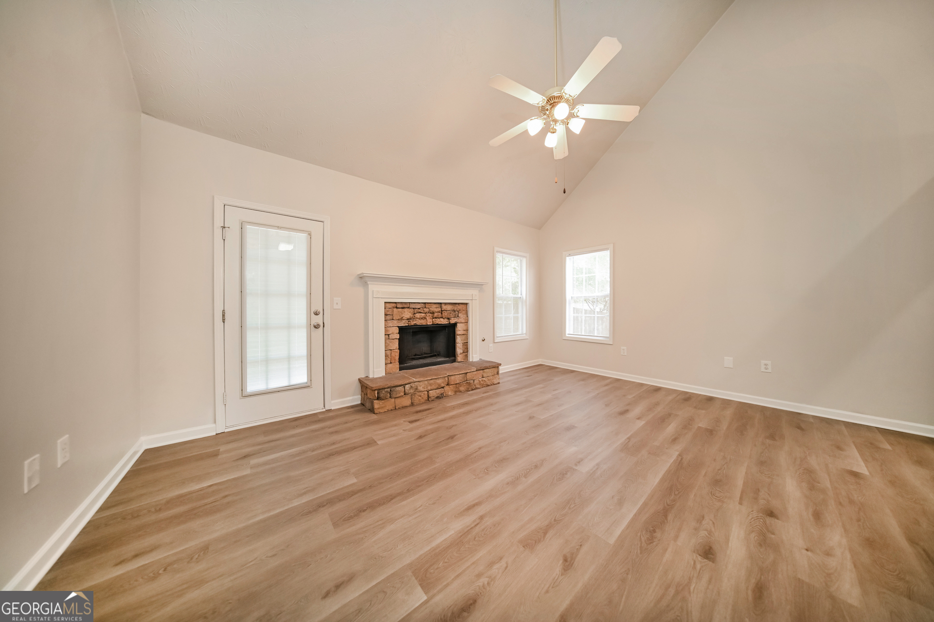 60 Freeman Way Covington, GA 30016 - Photo 3 of 17 a view of an empty room with wooden floor and a window