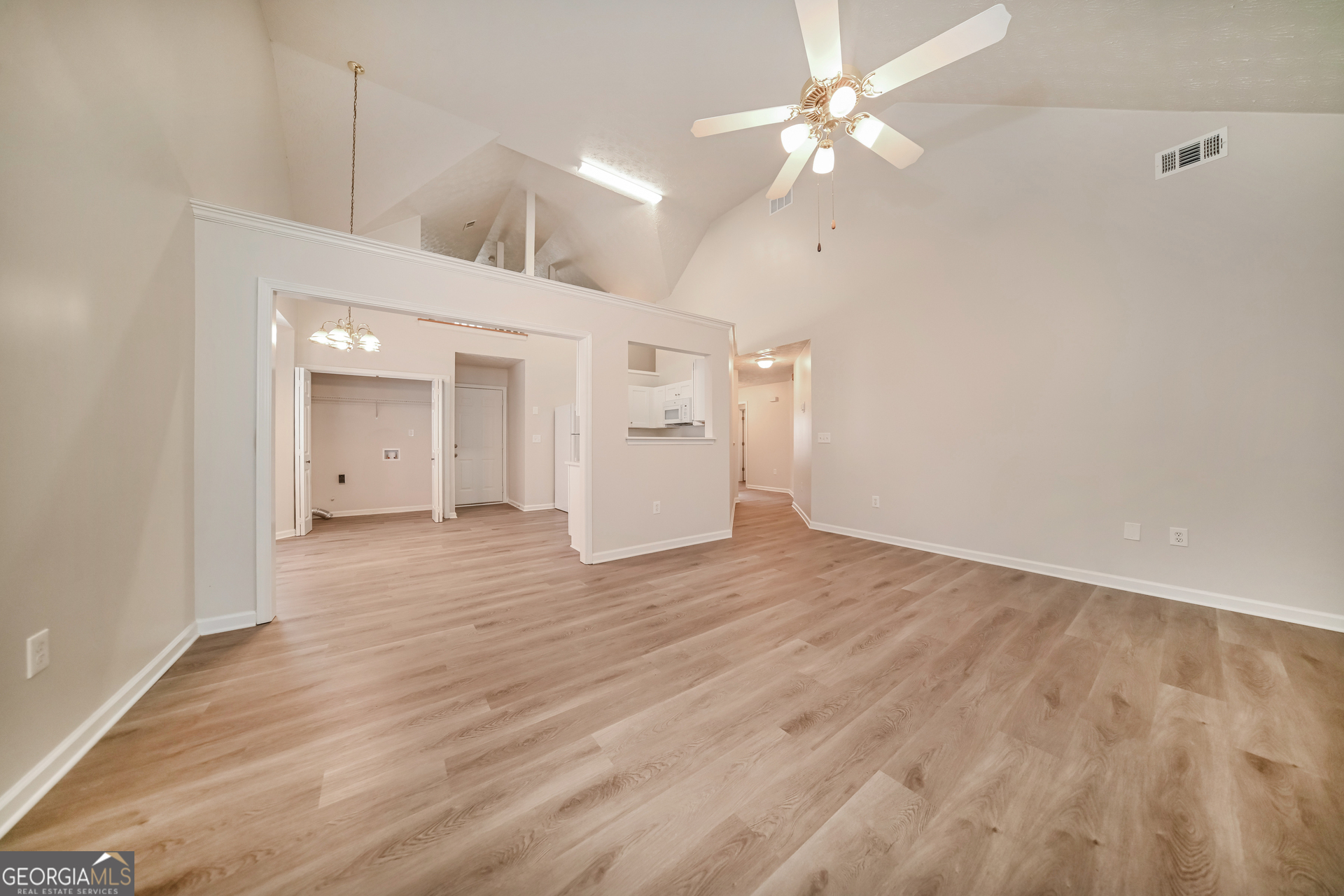 60 Freeman Way Covington, GA 30016 - Photo 4 of 17 a view of a room with wooden floor and a ceiling fan