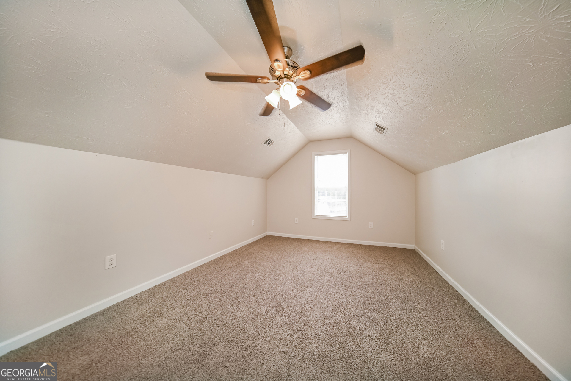 60 Freeman Way Covington, GA 30016 - Photo 6 of 17 an empty room with a window and a fan