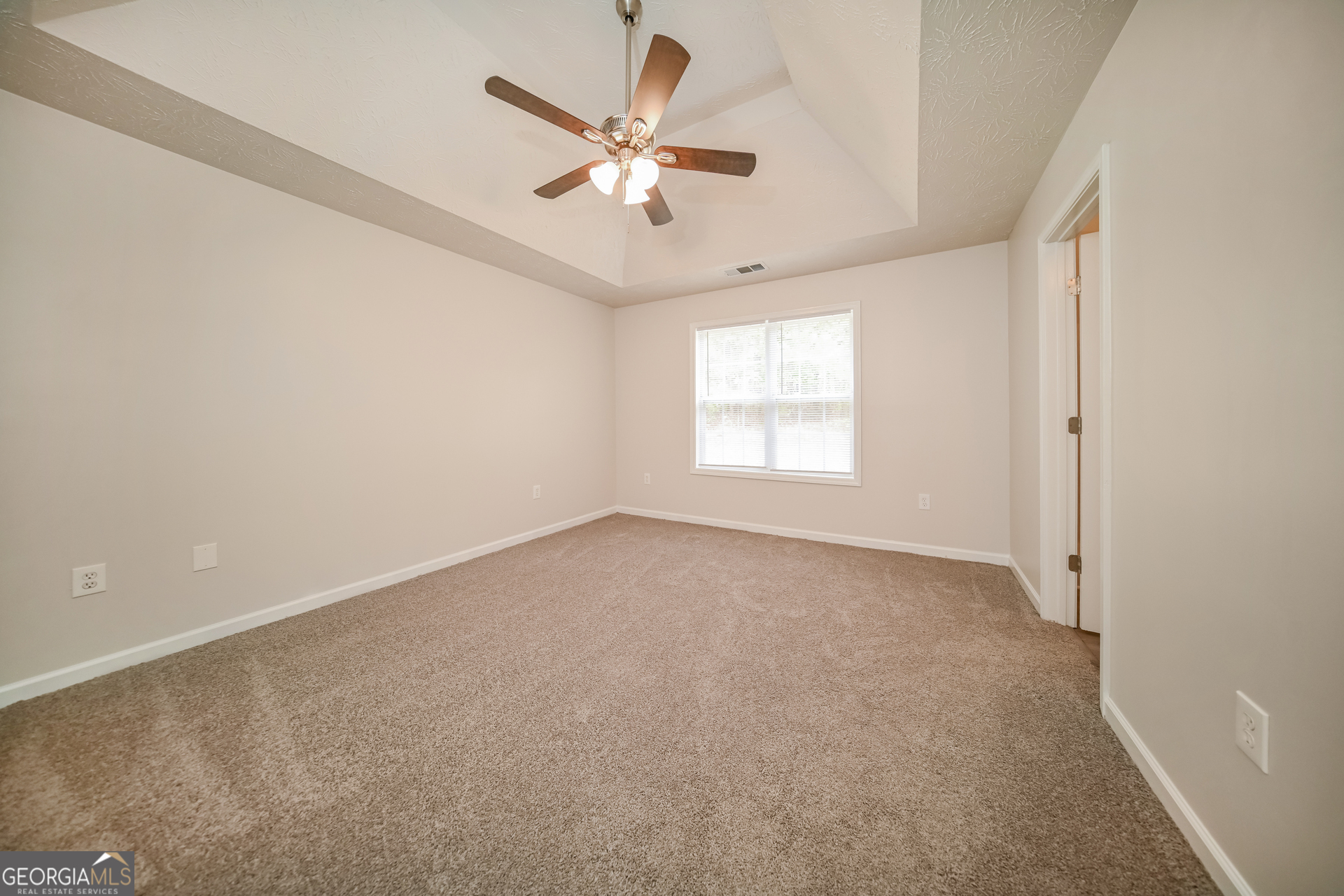 60 Freeman Way Covington, GA 30016 - Photo 8 of 17 an empty room with windows and fan