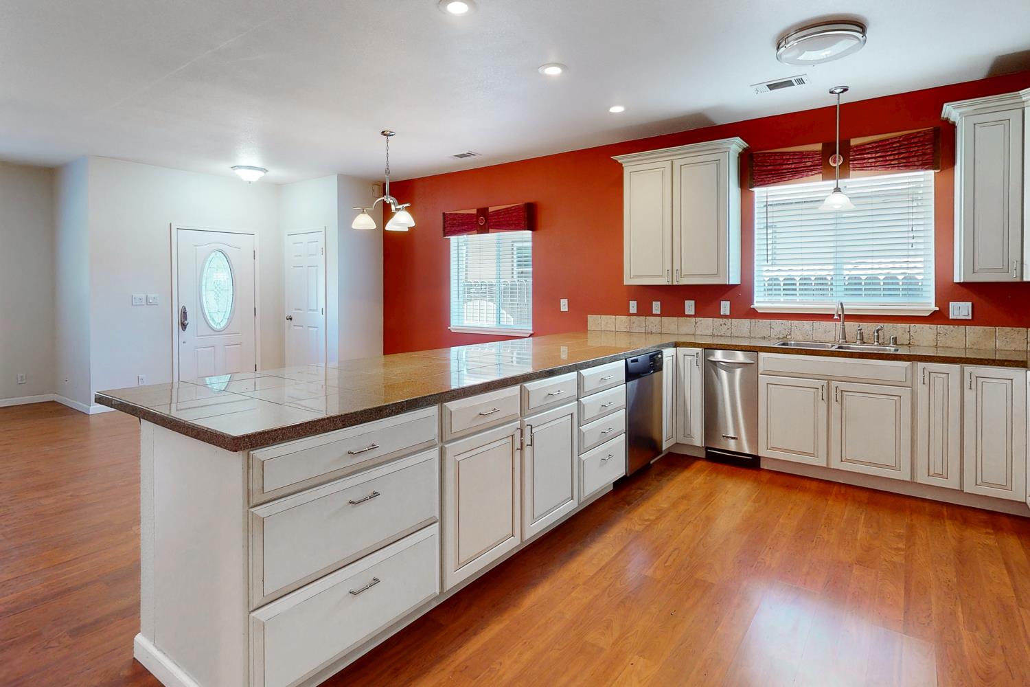 1835 Magnolia Street Gridley, CA 95948 - Photo 14 of 53 a kitchen with stainless steel appliances cabinets a large window and wooden floor
