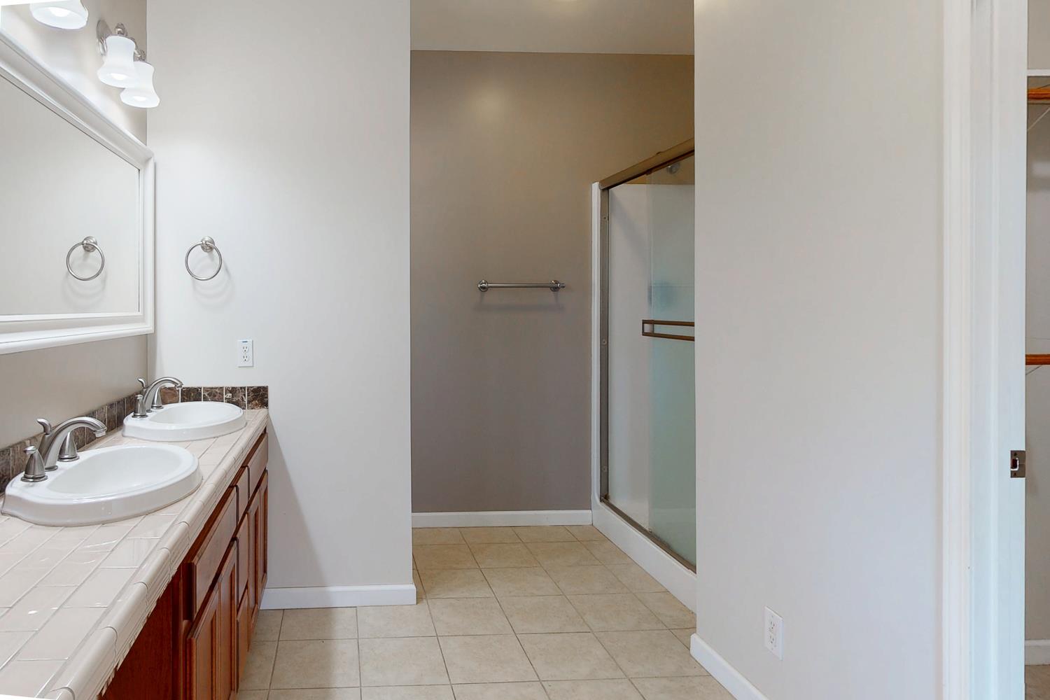 1835 Magnolia Street Gridley, CA 95948 - Photo 38 of 53 a bathroom with a sink a mirror and a shower