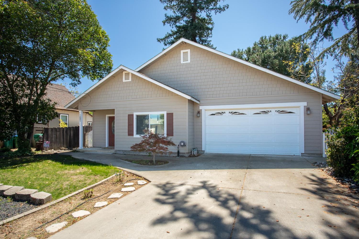 1835 Magnolia Street Gridley, CA 95948 - Photo 5 of 53 a front view of a house with a yard and garage