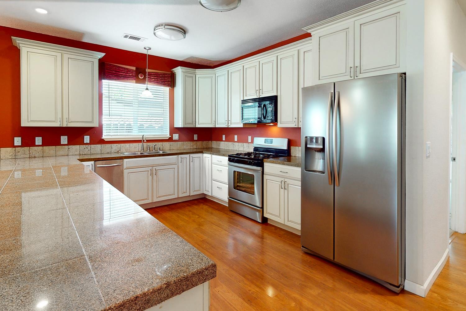 1835 Magnolia Street Gridley, CA 95948 - Photo 10 of 53 a kitchen with stainless steel appliances granite countertop a refrigerator a sink dishwasher a stove with wooden cabinets and floor