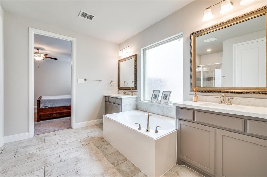 6117 Hall Road Frisco, TX 75034 - Photo 13 of 32 Bathroom with ensuite bathroom, two vanities, a garden tub, a shower stall, and a ceiling fan