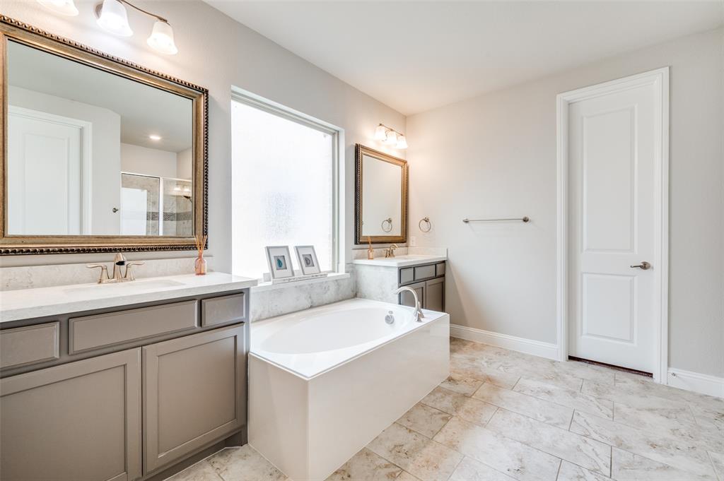 6117 Hall Road Frisco, TX 75034 - Photo 15 of 32 Full bath featuring two vanities, a garden tub, and a stall shower