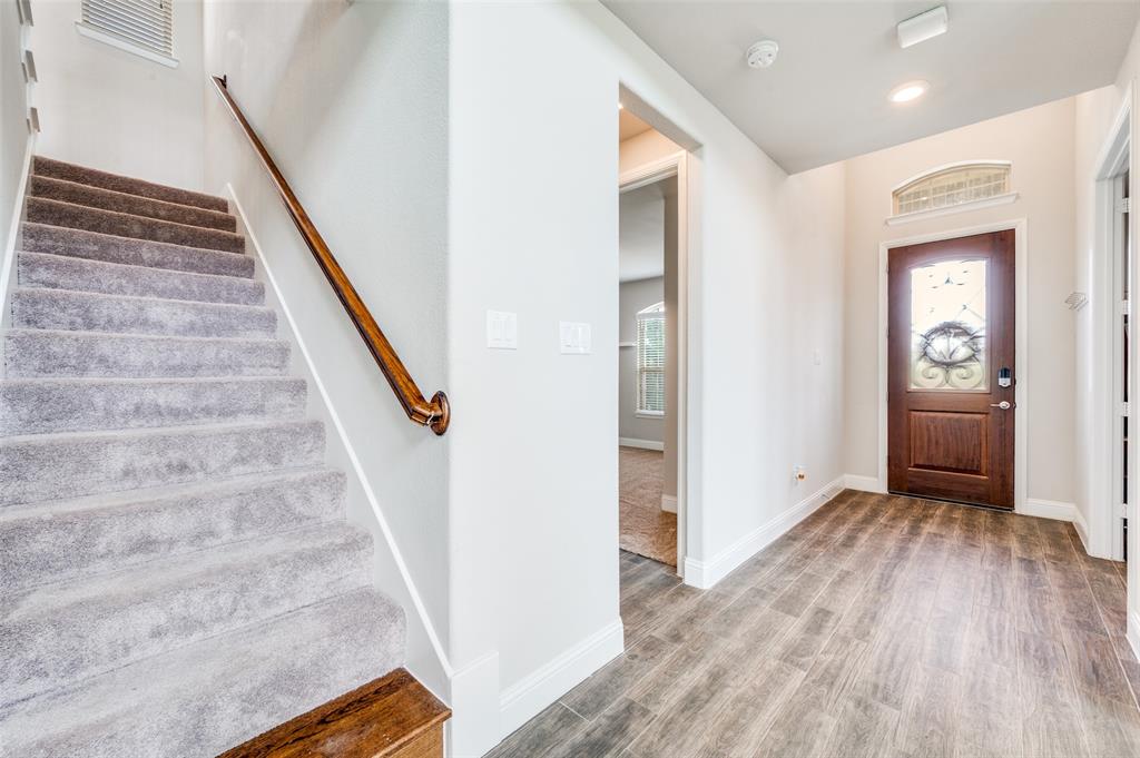 6117 Hall Road Frisco, TX 75034 - Photo 2 of 32 Foyer entrance with stairs and light wood-style floors